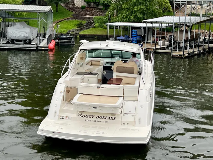  Yacht Photos Pics 2014 Sea Ray 410 Sundancer yacht docked at marina, rear view, calm water.
