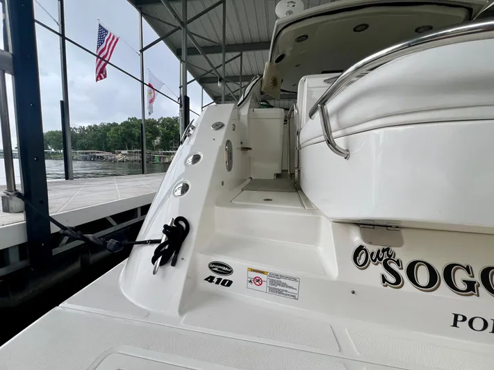  Yacht Photos Pics 2014 Sea Ray 410 Sundancer docked, featuring sleek design and American flags in the background.