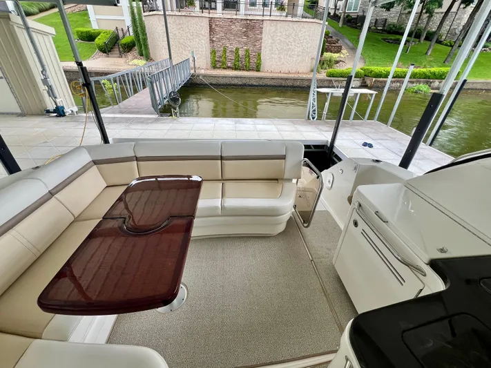  Yacht Photos Pics Luxurious seating area on 2014 Sea Ray 410 Sundancer yacht, docked by a serene waterfront.