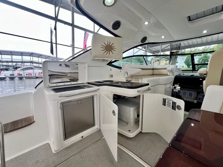  Yacht Photos Pics Luxurious interior of 2014 Sea Ray 410 Sundancer yacht with kitchenette and seating area.