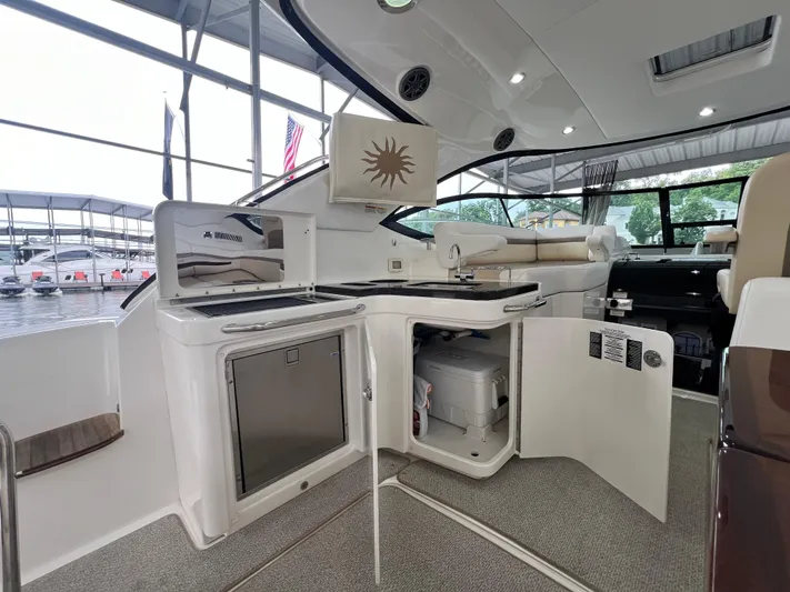  Yacht Photos Pics 2014 Sea Ray 410 Sundancer yacht interior with kitchenette and seating area.
