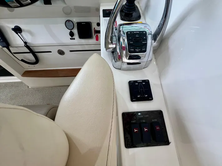 Yacht Photos Pics Helm controls of a 2014 Sea Ray 410 Sundancer boat, featuring throttle and trim tab switches.