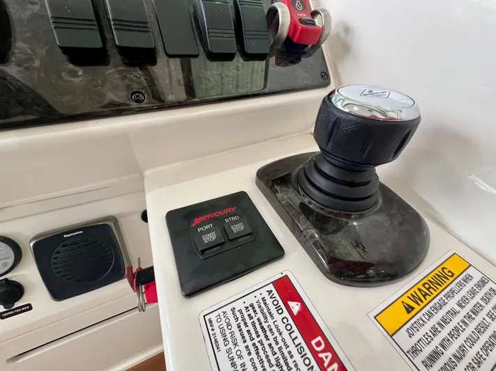  Yacht Photos Pics Control panel of a 2014 Sea Ray 410 Sundancer boat with joystick and warning labels.