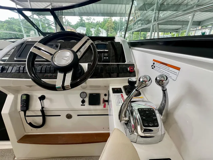  Yacht Photos Pics Helm of 2014 Sea Ray 410 Sundancer with steering wheel and control levers.