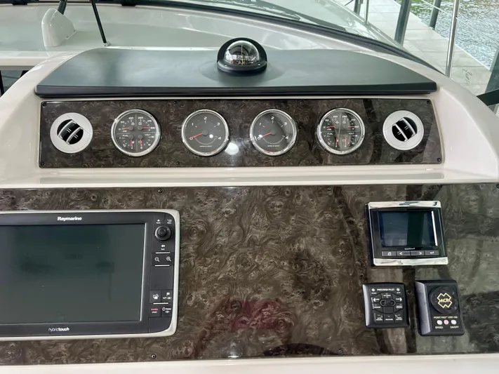  Yacht Photos Pics Control panel of a 2014 Sea Ray 410 Sundancer with gauges and navigation equipment.