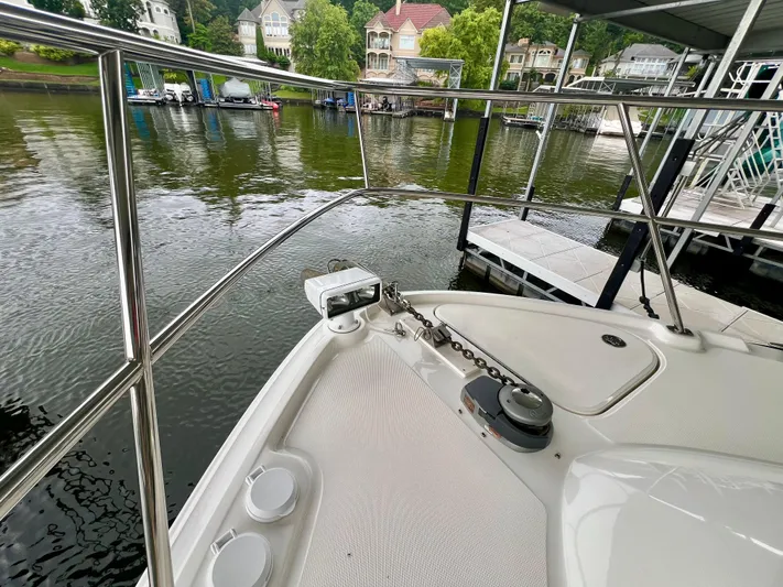  Yacht Photos Pics 2014 Sea Ray 410 Sundancer bow with anchor chain, docked by waterfront homes.