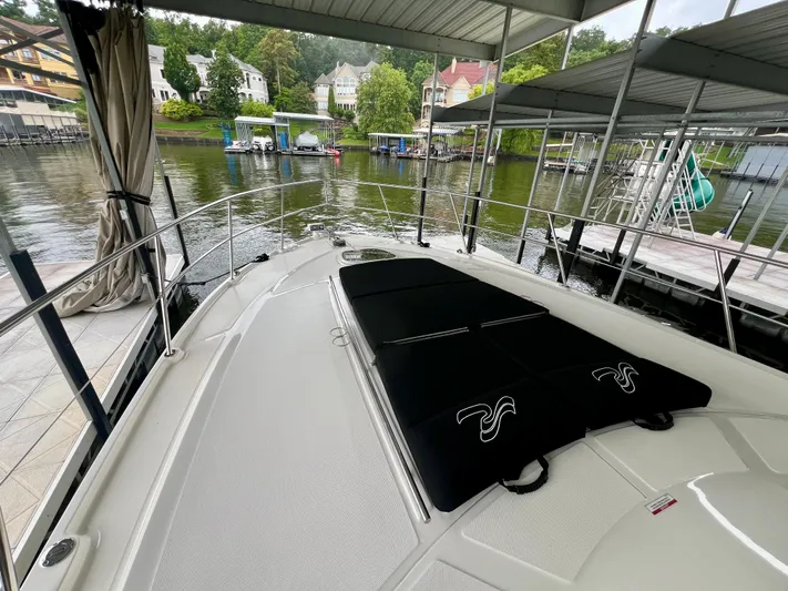  Yacht Photos Pics 2014 Sea Ray 410 Sundancer yacht docked, featuring spacious deck and scenic waterfront view.