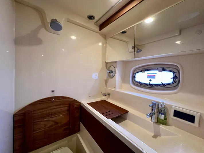 Yacht Photos Pics Luxurious bathroom interior of 2014 Sea Ray 410 Sundancer yacht with modern fixtures.