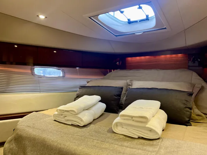  Yacht Photos Pics Luxurious cabin interior of 2014 Sea Ray 410 Sundancer yacht with skylight and plush bedding.