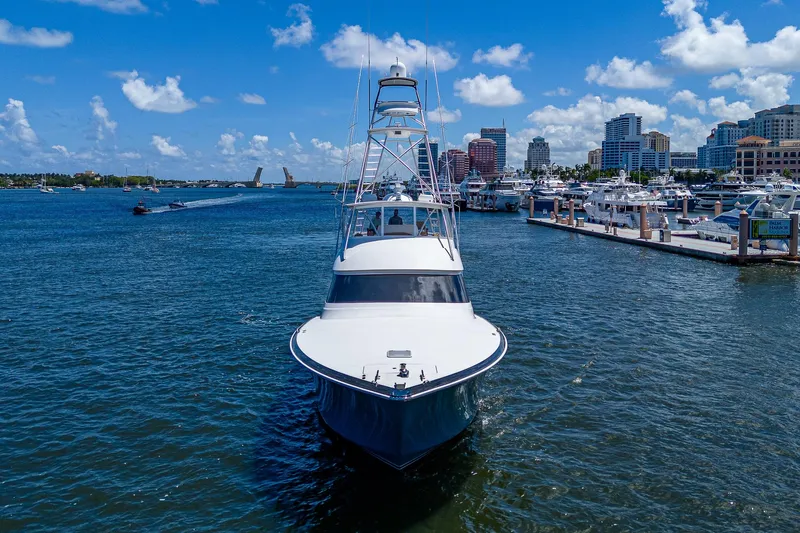 Gypsea Yacht Photos Pics 2015 Viking 66 Open yacht on water near city skyline and marina.