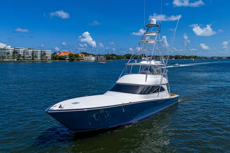 Gypsea Yacht Photos Pics 2015 Viking 66 Open yacht cruising on a sunny day, blue sky, and calm waters.