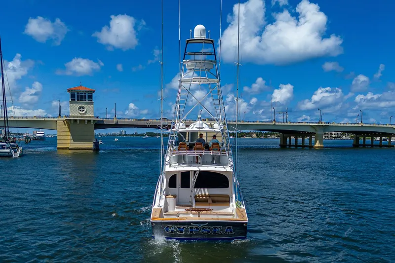 Gypsea Yacht Photos Pics 2015 Viking 66 Open yacht on water near a bridge under a blue sky.