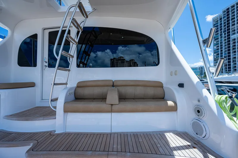 Gypsea Yacht Photos Pics 2015 Viking 66 Open yacht with outdoor seating and ladder, docked in a marina.