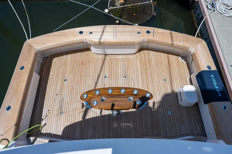 Gypsea Yacht Photos Pics 2015 Viking 66 Open yacht deck with wooden flooring and fishing rod holders.
