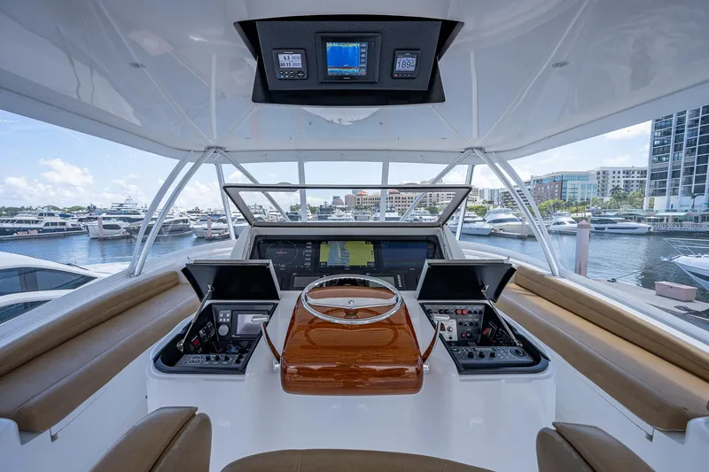 Gypsea Yacht Photos Pics 2015 Viking 66 Open yacht helm with advanced navigation systems, docked at a marina.