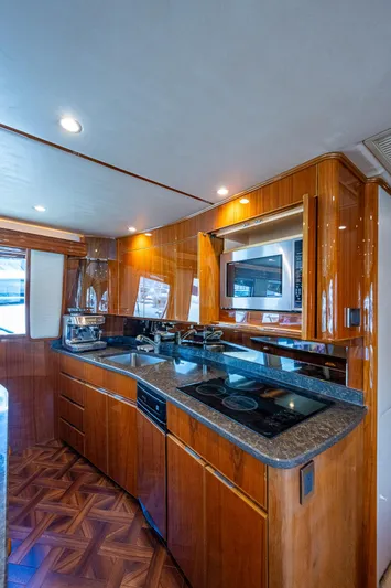 Gypsea Yacht Photos Pics 2015 Viking 66 Open yacht kitchen with modern appliances and wood cabinetry.