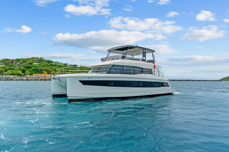 Mona Lisa Yacht Photos Pics 2024 Fountaine Pajot MY.6 yacht cruising on blue waters under a clear sky.