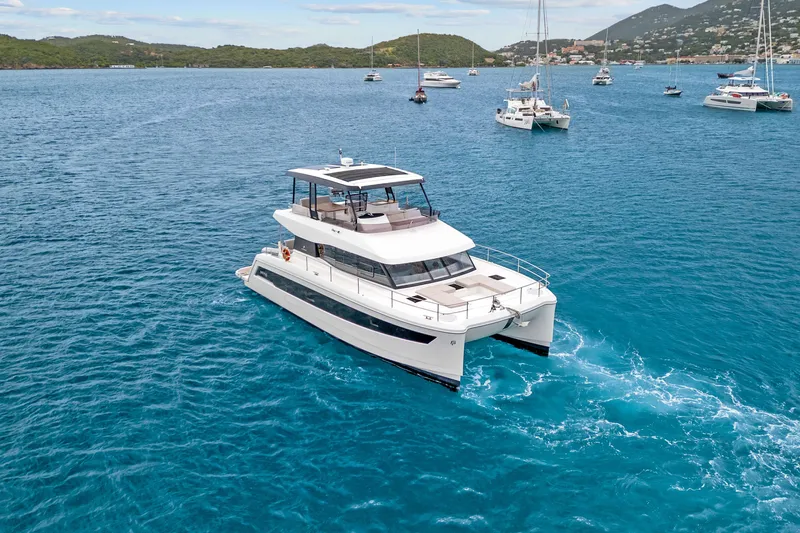 Mona Lisa Yacht Photos Pics 2024 Fountaine Pajot MY.6 yacht cruising in a scenic bay with other boats.