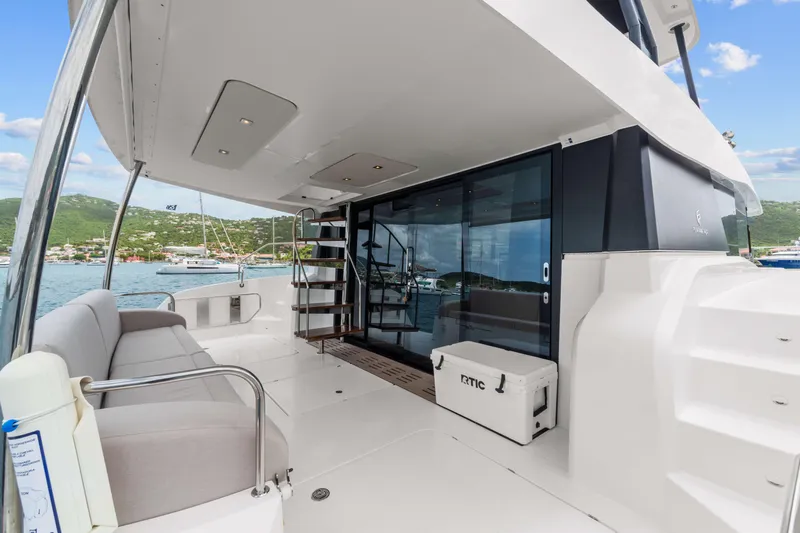 Mona Lisa Yacht Photos Pics 2024 Fountaine Pajot MY.6 yacht deck with seating, stairs, and ocean view.