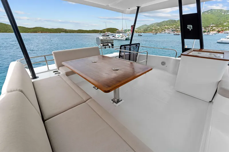 Mona Lisa Yacht Photos Pics 2024 Fountaine Pajot MY6 yacht deck with seating, table, and ocean view.