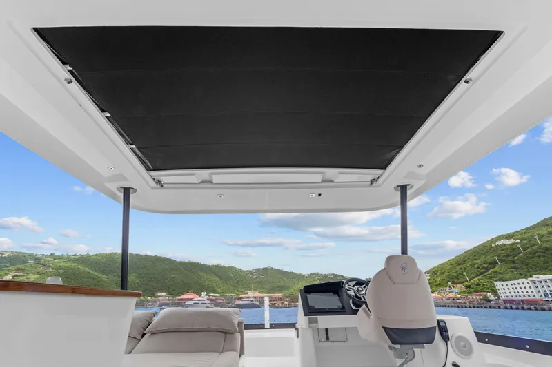 Mona Lisa Yacht Photos Pics 2024 Fountaine Pajot MY.6 yacht helm with scenic ocean and hillside view.