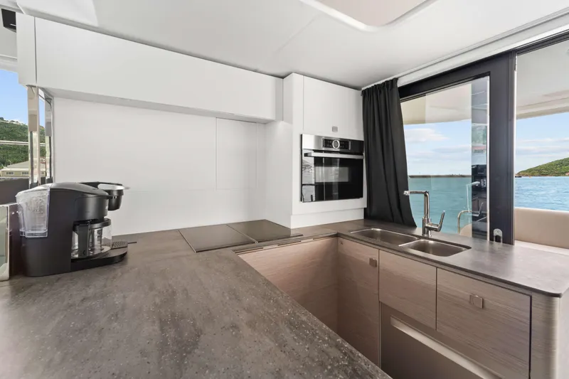 Mona Lisa Yacht Photos Pics Modern kitchen interior on 2024 Fountaine Pajot MY.6 yacht with ocean view.