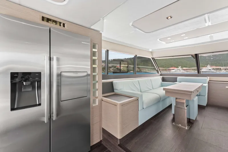 Mona Lisa Yacht Photos Pics Luxurious interior of 2024 Fountaine Pajot MY.6 yacht with modern kitchen and seating area.