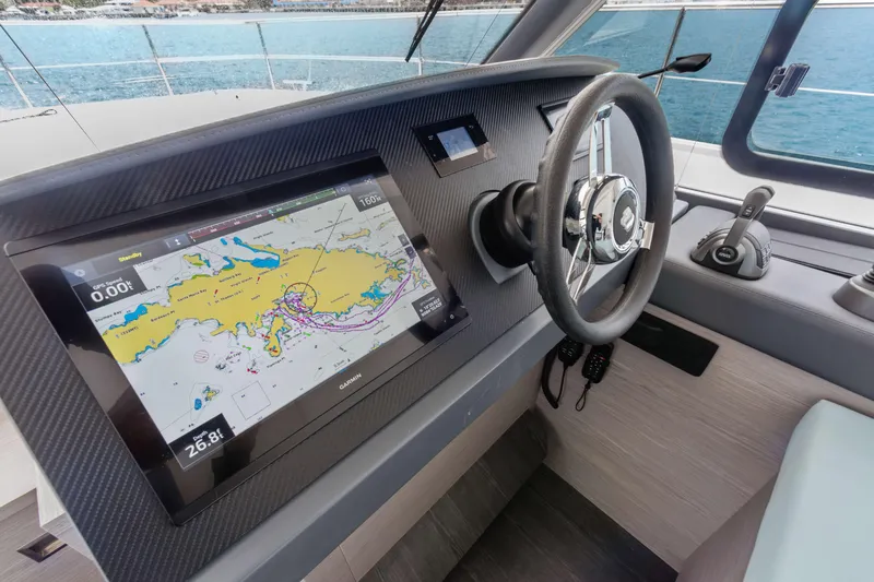 Mona Lisa Yacht Photos Pics 2024 Fountaine Pajot MY.6 helm with navigation display and steering wheel.