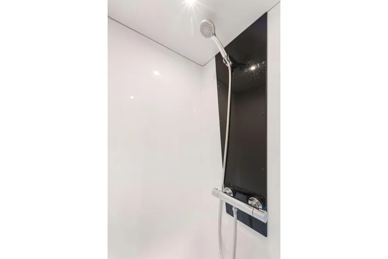 Mona Lisa Yacht Photos Pics Modern shower in 2024 Fountaine Pajot MY.6 yacht, featuring sleek design and chrome fixtures.