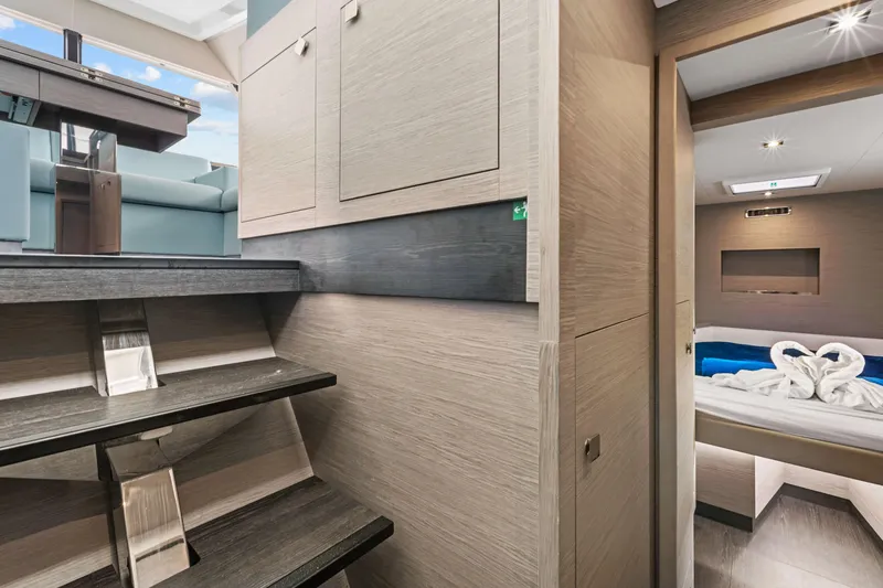 Mona Lisa Yacht Photos Pics 2024 Fountaine Pajot MY.6 interior with modern stairs, cozy cabin, and elegant decor.