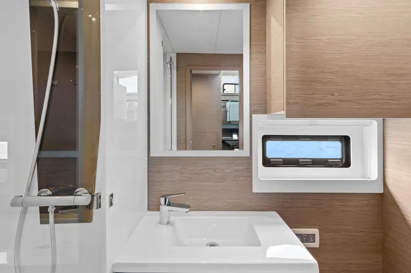 Mona Lisa Yacht Photos Pics Modern bathroom interior of 2024 Fountaine Pajot MY.6 yacht with sleek fixtures.