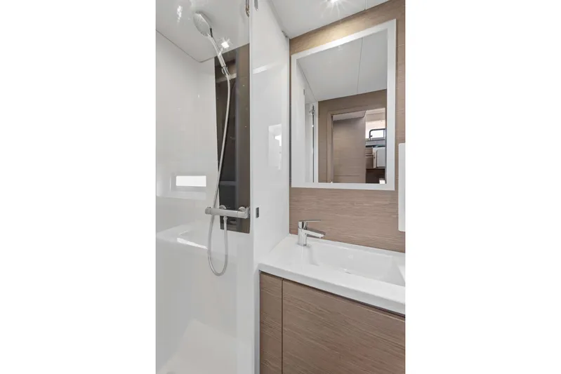 Mona Lisa Yacht Photos Pics Modern bathroom interior on 2024 Fountaine Pajot MY.6 yacht, featuring sleek shower and vanity.
