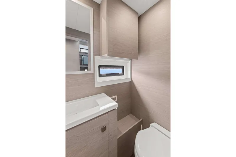 Mona Lisa Yacht Photos Pics Modern bathroom interior of 2024 Fountaine Pajot MY.6 yacht, featuring sleek design and compact layout.