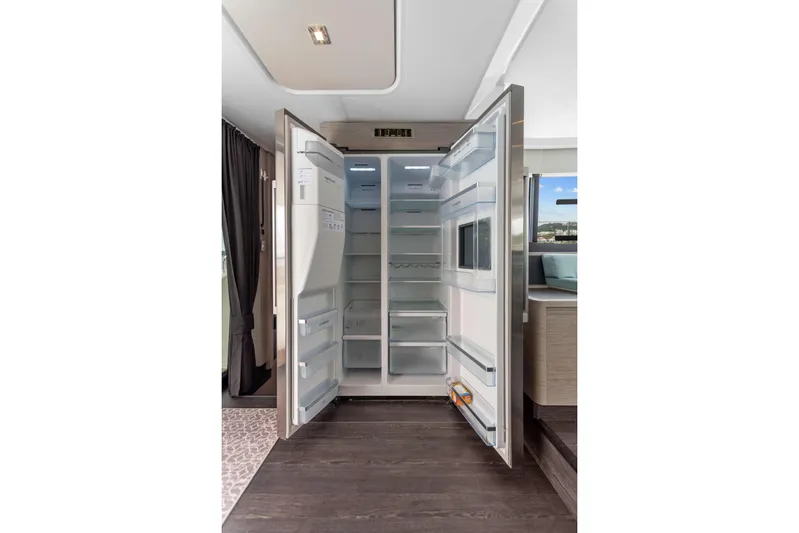 Mona Lisa Yacht Photos Pics Open refrigerator inside 2024 Fountaine Pajot MY.6 yacht, showcasing spacious interior design.