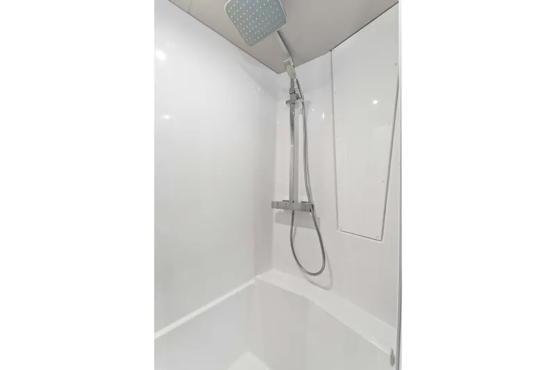 Mona Lisa Yacht Photos Pics Modern shower in 2024 Fountaine Pajot MY.6 yacht, featuring sleek design and chrome fixtures.