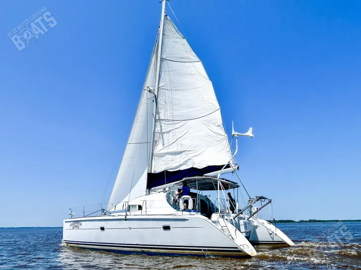 Kansakota Winds Yacht Photos Pics 2003 Lagoon 410-S2 catamaran sailing on open water under clear blue skies.