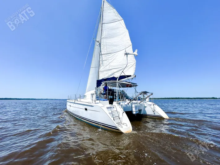 Kansakota Winds Yacht Photos Pics 2003 Lagoon 410-S2 catamaran sailing on open water under clear blue sky.