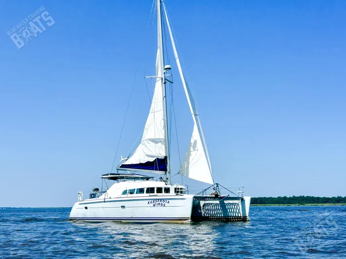 Kansakota Winds Yacht Photos Pics 2003 Lagoon 410-S2 catamaran sailing on open water under clear blue sky.