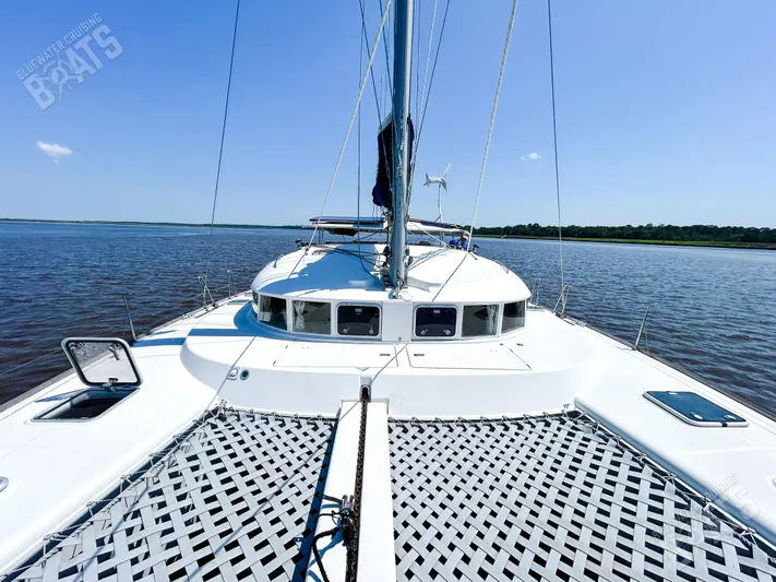 Kansakota Winds Yacht Photos Pics 2003 Lagoon 410-S2 catamaran on calm water under clear blue sky.