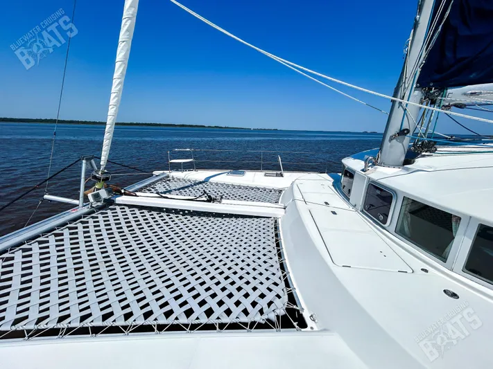 Kansakota Winds Yacht Photos Pics 2003 Lagoon 410-S2 catamaran on calm waters under clear blue sky.