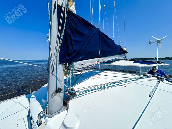 Kansakota Winds Yacht Photos Pics 2003 Lagoon 410-S2 catamaran with blue sail cover on calm water.