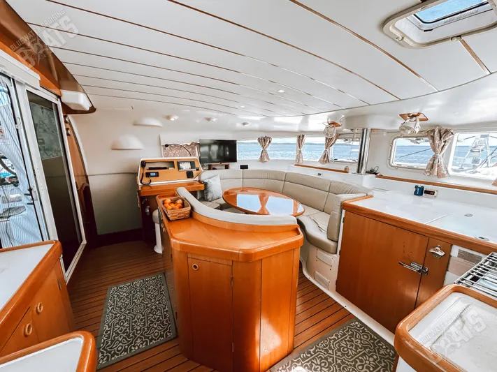 Kansakota Winds Yacht Photos Pics Interior of 2003 Lagoon 410-S2 catamaran with elegant wood finish and spacious seating area.