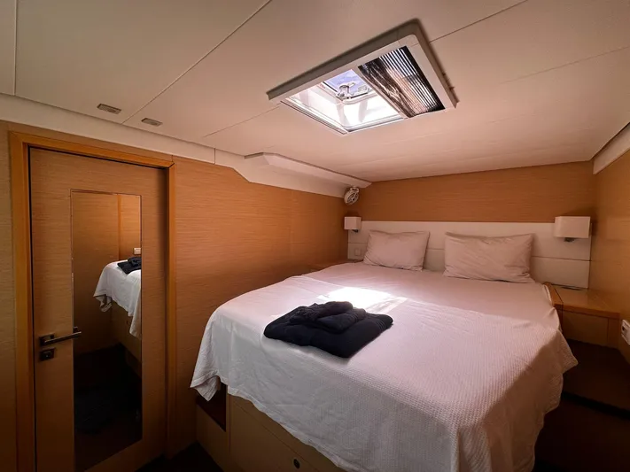  Yacht Photos Pics Luxurious cabin interior of 2012 Lagoon 620 yacht with skylight and cozy bedding.