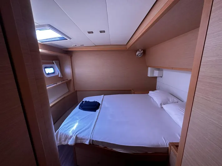  Yacht Photos Pics Luxurious cabin interior of 2012 Lagoon 620 yacht with cozy bed and natural lighting.