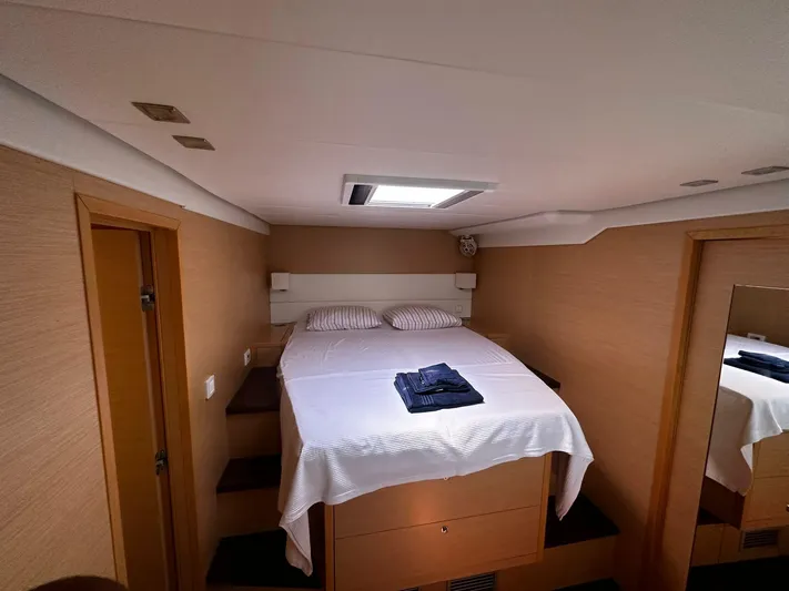  Yacht Photos Pics Luxurious cabin interior of 2012 Lagoon 620 yacht with cozy bed and modern design.