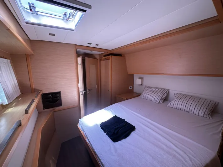  Yacht Photos Pics Luxurious cabin interior of 2012 Lagoon 620 yacht with skylight and cozy bedding.