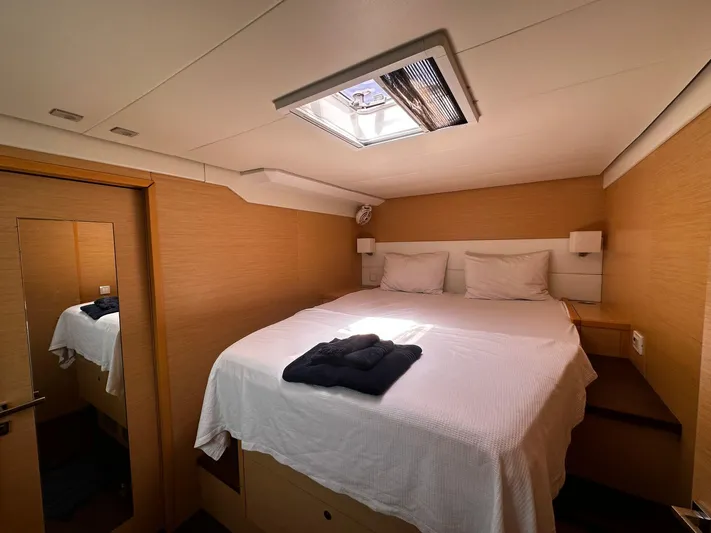  Yacht Photos Pics Luxurious cabin interior of a 2012 Lagoon 620 yacht with a cozy bed and skylight.