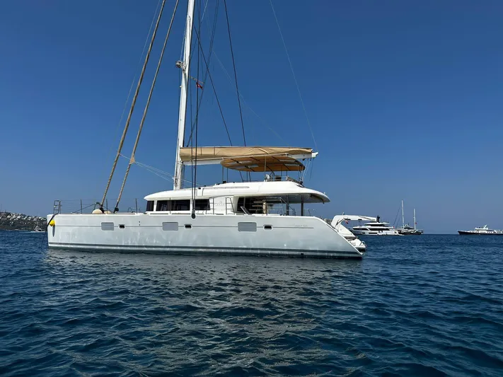  Yacht Photos Pics Lagoon 620 yacht from 2012 sailing on clear blue waters under a sunny sky.