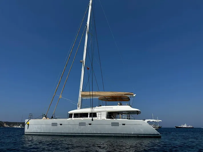  Yacht Photos Pics 2012 Lagoon 620 catamaran sailing on calm blue waters under clear skies.