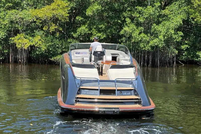 Sea Sea Yacht Photos Pics 2013 Riva Rivarama Super yacht cruising on a serene waterway, surrounded by lush greenery.